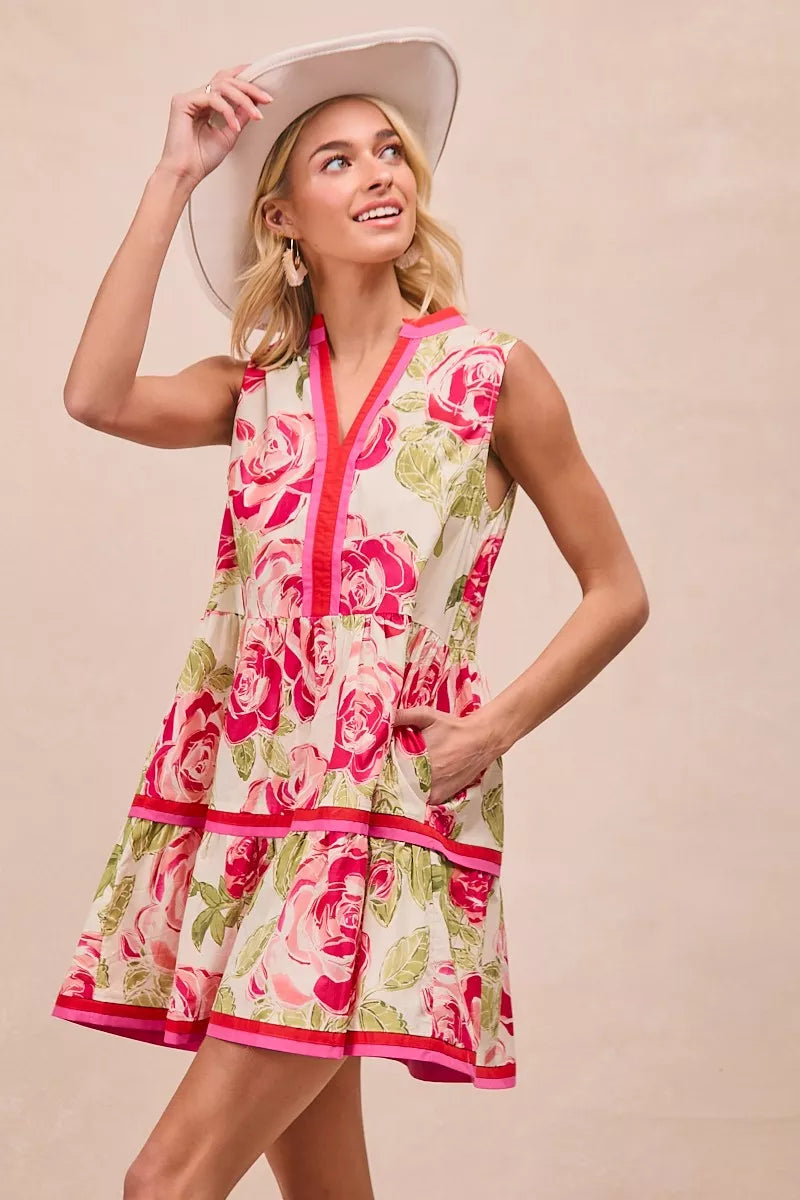 Model wearing BiBi Floral Woven Contrast Edge Tiered Ruffle Mini Dress in a summer garden setting