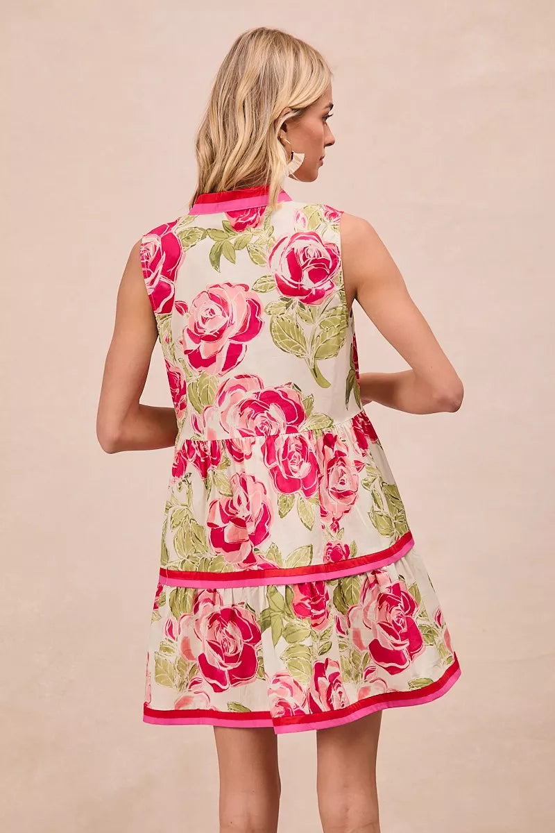 Model wearing BiBi Floral Woven Contrast Edge Tiered Ruffle Mini Dress in a summer garden setting