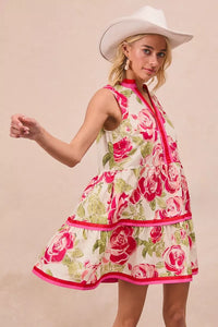 Model wearing BiBi Floral Woven Contrast Edge Tiered Ruffle Mini Dress in a summer garden setting