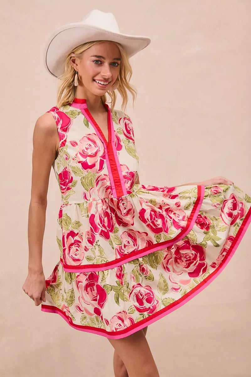 Model wearing BiBi Floral Woven Contrast Edge Tiered Ruffle Mini Dress in a summer garden setting
