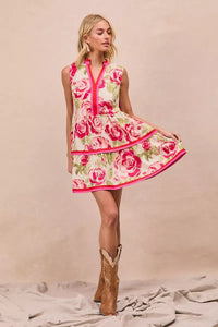 Model wearing BiBi Floral Woven Contrast Edge Tiered Ruffle Mini Dress in a summer garden setting