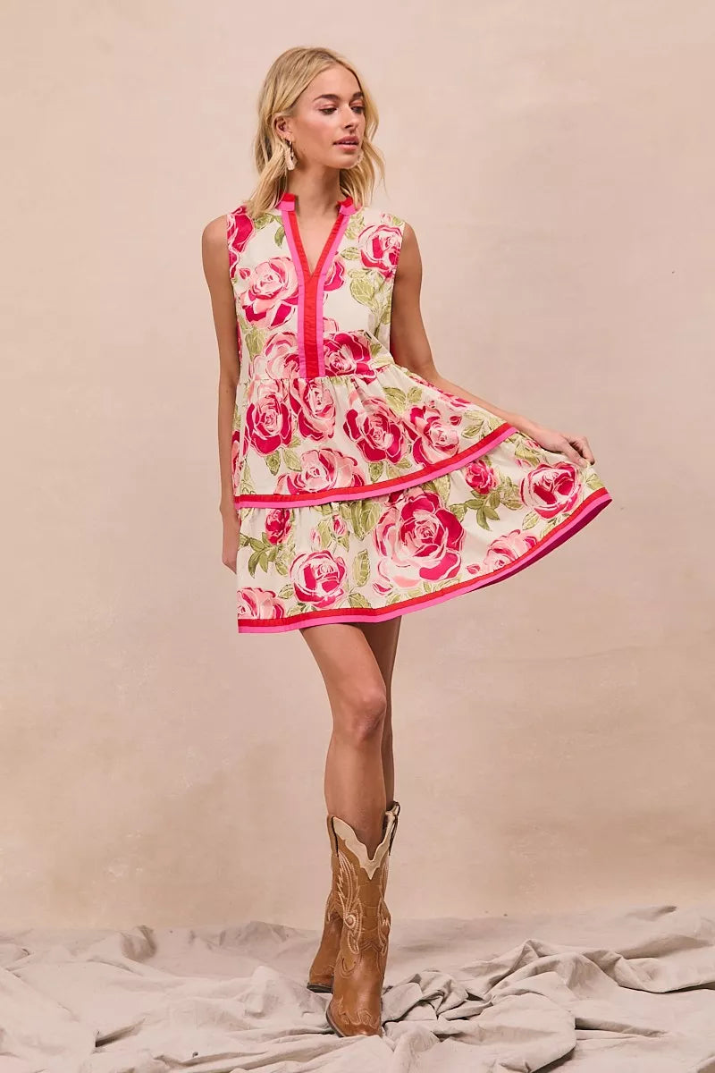 Model wearing BiBi Floral Woven Contrast Edge Tiered Ruffle Mini Dress in a summer garden setting